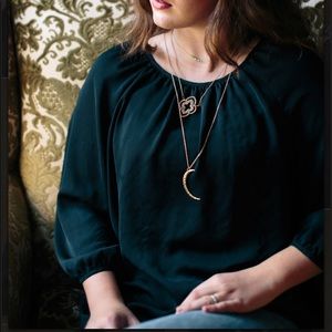 Crescent moon long pendent in gold tone.